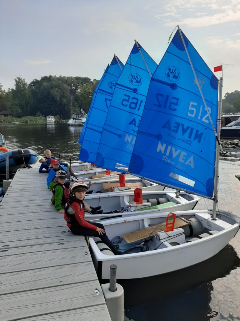  szkółka żeglarska optimisty podczas półkolonii schodzą na trening